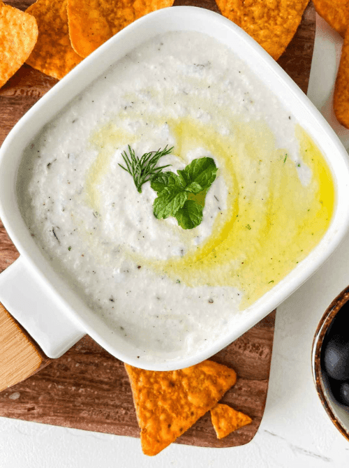 Creamy Turkish yogurt haydari dip drizzled with olive oil and fresh herbs, served with tortilla chips as one of the last minute dips for dips for your Super Bowl party.