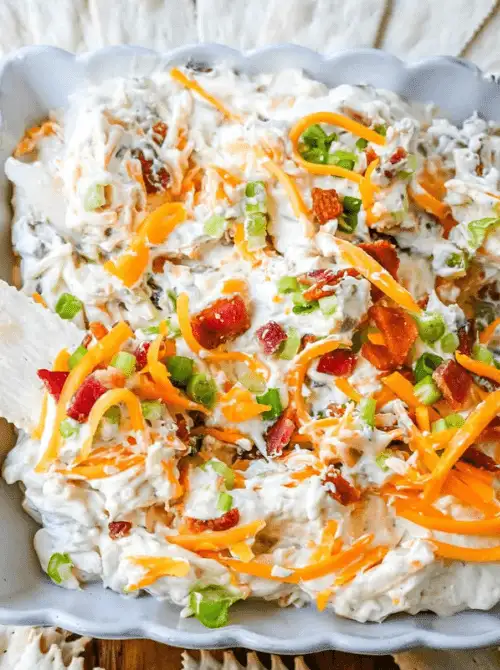 Creamy cheese dip with bacon, shredded cheese, and green onions, a last minute Super Bowl party dip recipe that’s easy to spread and scoop.