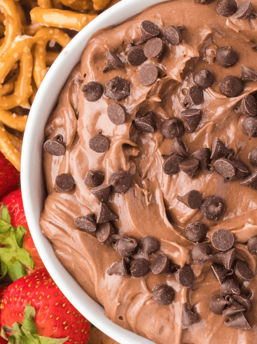 Creamy chocolate dip topped with chocolate chips, served with pretzels and strawberries for a last minute Super Bowl party dip recipe.