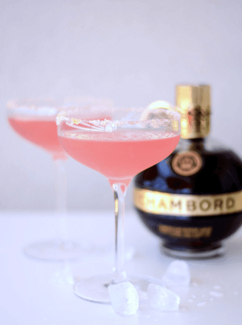 Pink Cocktail Ideas for a Galentine’s Day Party featuring French martinis made with Chambord in coupe glasses with sugar rims
