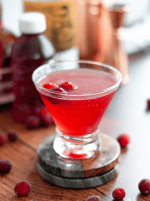 Pink Cocktail Ideas for a Galentine’s Day Party featuring bacon Bloody Mary cocktails garnished with celery, olives, and crispy bacon