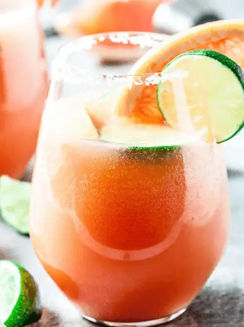 Pink Cocktail Ideas for a Galentine’s Day Party featuring a grapefruit paloma cocktail with salted rim and fresh citrus garnish