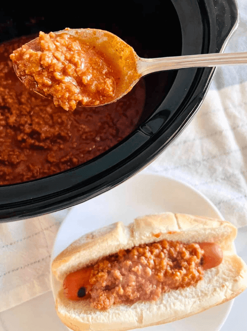 Spoonful of hot dog chili from a slow cooker being added to a bun, part of easy crock pot recipes for a last minute Super Bowl party.