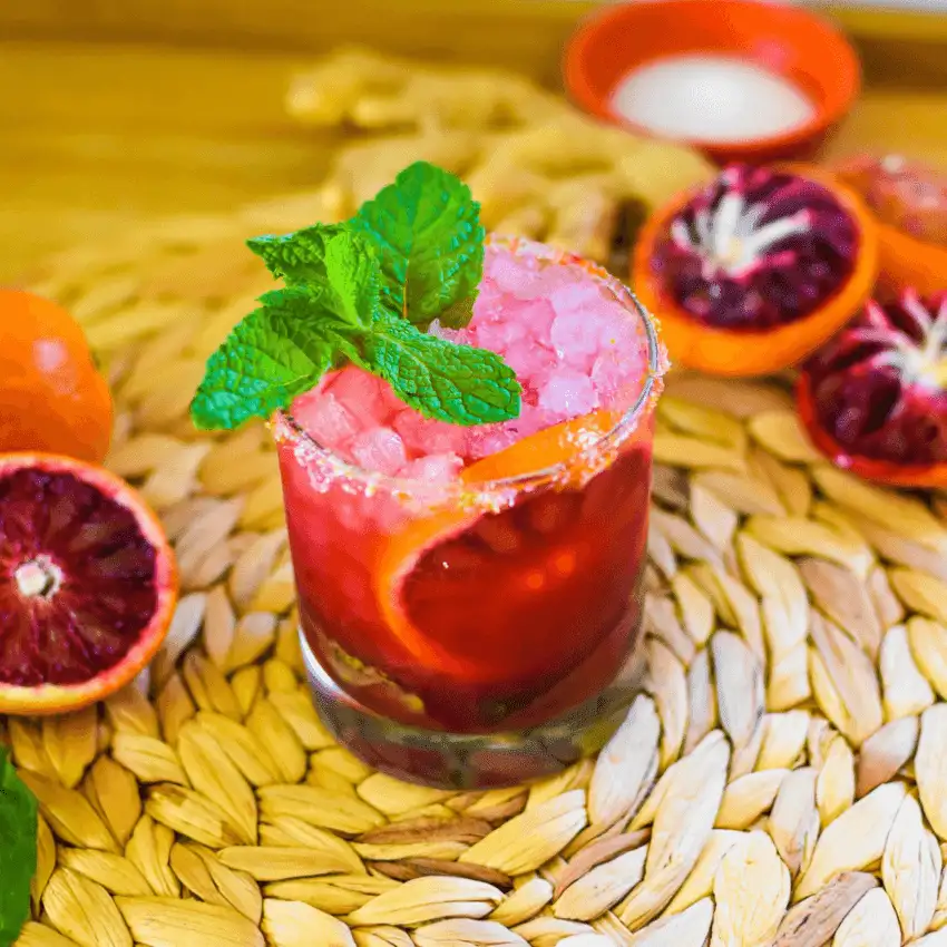Close-up of a citrus mocktail served for a Galantine's Day Party, showcasing easy mocktail ideas with fresh fruit and mint garnish.