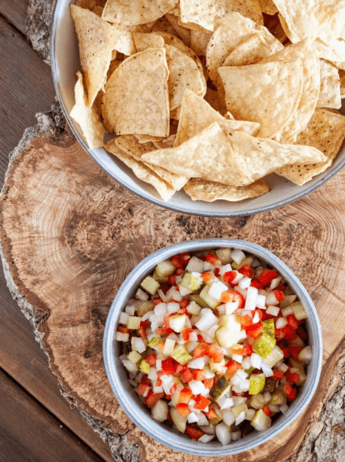 Pickle de gallo salsa served with tortilla chips, a cheap tailgate food and simple Super Bowl appetizer for a crowd.