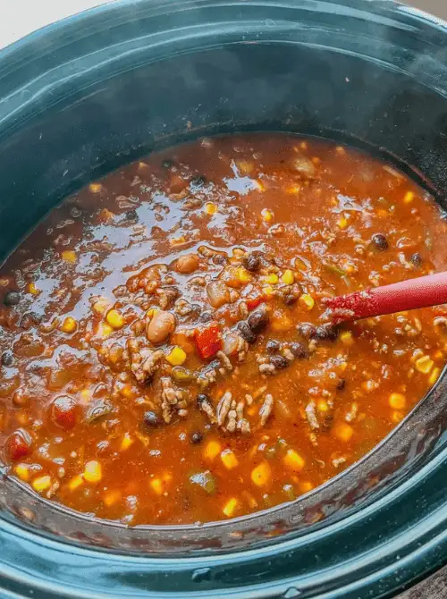 Slow cooker taco soup filled with beans, corn, and tomatoes, featured in easy crock pot recipes for a last minute Super Bowl party.