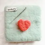 Needle-felted heart made with wool roving on a foam pad, a handmade Valentine’s DIY craft created on a Dollar Tree budget.