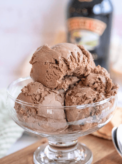 Scoops of Bailey’s Irish cream ice cream in a glass dessert bowl, a make-ahead dessert for St. Patrick’s Day that works well for desserts on a budget.