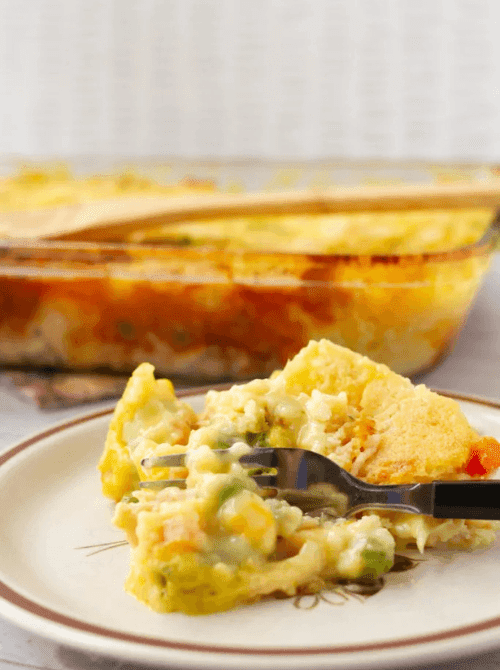 Slice of creamy chicken potato casserole with mixed vegetables served on a plate, showing hearty chicken casseroles that work well for easy weeknight dinners.