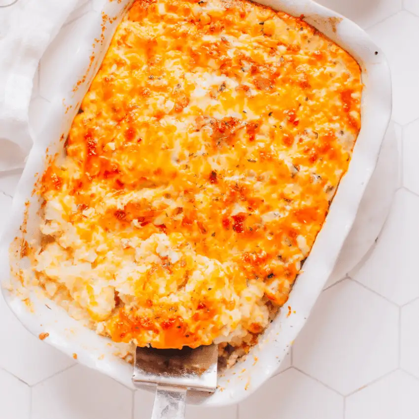 Overhead view of a cheesy baked chicken casserole with a golden melted topping in a white baking dish, showing hearty chicken casseroles ideal for easy weeknight dinners.