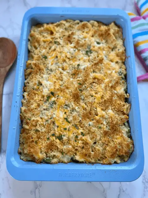 Overhead view of a baked chicken casserole with a golden breadcrumb topping in a blue baking dish, a classic example of chicken casseroles made for easy weeknight dinners.