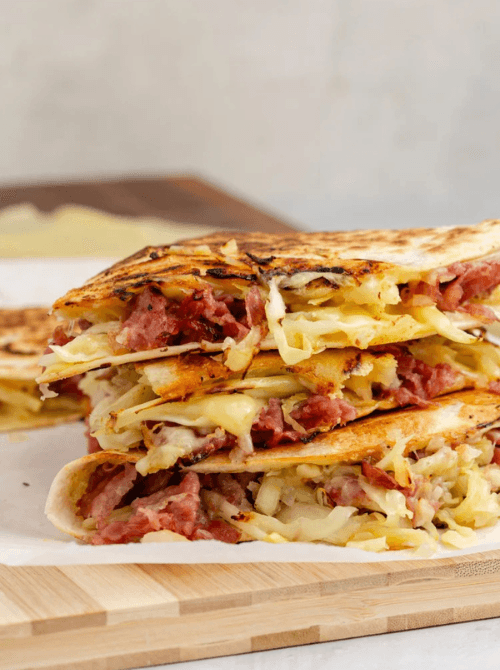 Grilled corned beef quesadillas layered with melted cheese and cabbage, a hearty Irish party food option for a St. Patrick’s Day celebration.