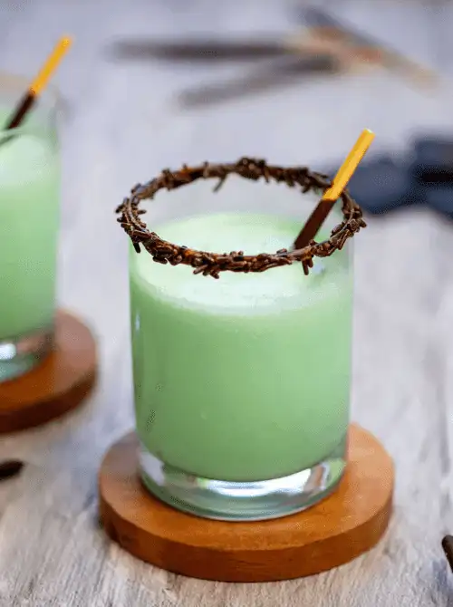 Mint green grasshopper drink with chocolate sprinkle rim, festive no-bake St. Patrick’s Day dessert on a budget.