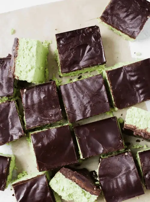 Mint chocolate no-bake bars with dark chocolate topping, festive St. Patrick’s Day dessert on a budget.