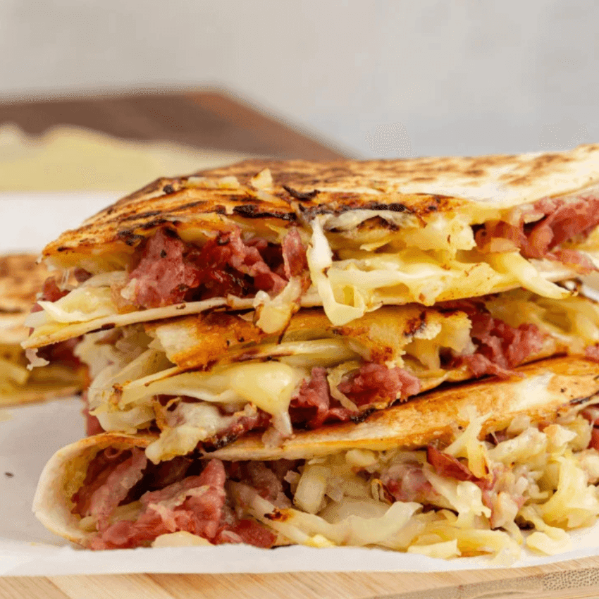 Grilled corned beef quesadillas layered with melted cheese and cabbage, a hearty Irish party food option for a St. Patrick’s Day celebration.