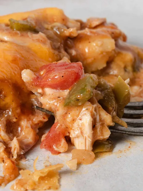 Close-up of a creamy chicken casserole with peppers and onions coated in a savory sauce, highlighting flavorful chicken casseroles suited for easy weeknight dinners.