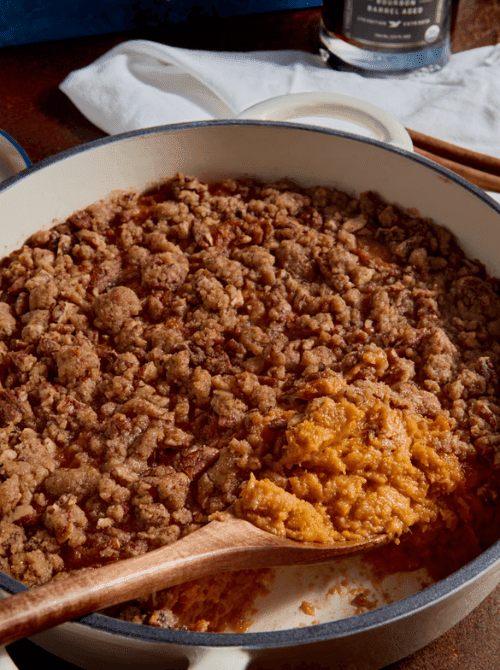 Ground turkey and sweet potato mixture cooking in a skillet with a wooden spoon, part of making super easy casseroles and hearty family dinner ideas.