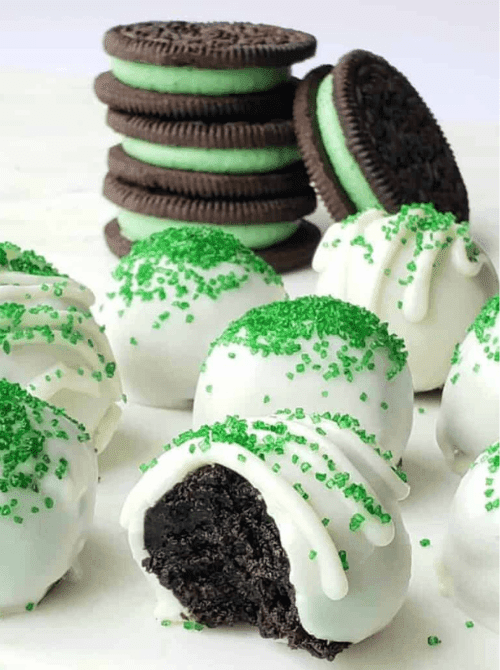 Mint Oreo truffle balls coated in white chocolate and green sprinkles, festive no-bake St. Patrick’s Day dessert on a budget.