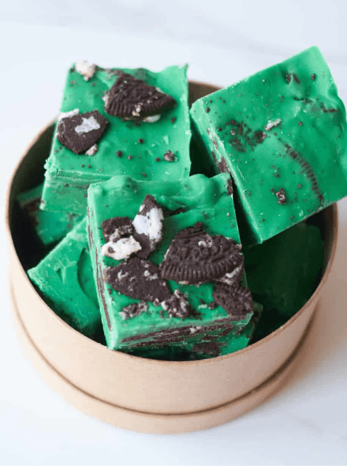 Mint Oreo no-bake fudge topped with cookie pieces, festive St. Patrick’s Day dessert on a budget.