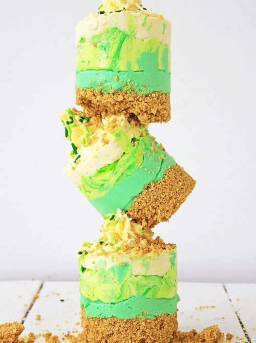 Layered mint no-bake cheesecake bars with graham cracker crust, festive St. Patrick’s Day dessert on a budget.