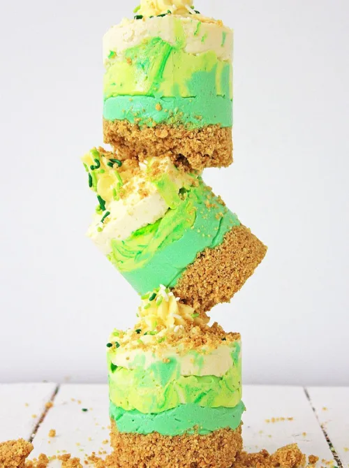 Layered mint no-bake cheesecake bars with graham cracker crust, festive St. Patrick’s Day dessert on a budget.