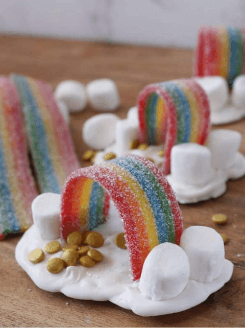 Rainbow candy and marshmallow treats arranged like mini rainbows, festive no-bake St. Patrick’s Day dessert on a budget.