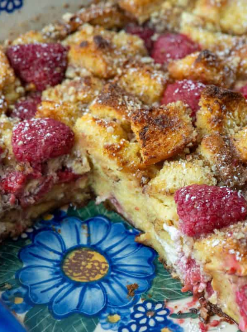 Raspberry brioche French toast casserole baked with custard-soaked bread cubes and fresh raspberries, a sweet option for make-ahead Easter brunch casseroles perfect for spring brunch.