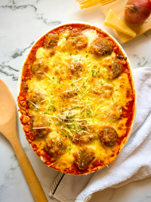 Cheesy baked meatball casserole in marinara sauce with a golden melted topping, a classic comfort casseroles recipe for easy comfort food and recipes for busy nights.