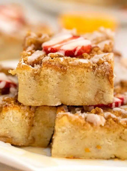 Soft baked apple fritter squares topped with crumb streusel and icing, a sweet bakery-style option for make-ahead Easter brunch casseroles served for a holiday brunch.