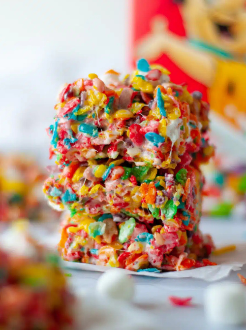 Stack of colorful cereal marshmallow squares, a festive no-bake Easter-themed dessert for a bake sale, packed with bright fruity cereal and sweet marshmallow coating.
