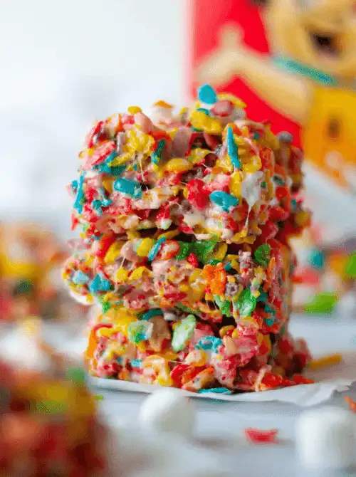 Stack of colorful cereal marshmallow squares, a festive no-bake Easter-themed dessert for a bake sale, packed with bright fruity cereal and sweet marshmallow coating.
