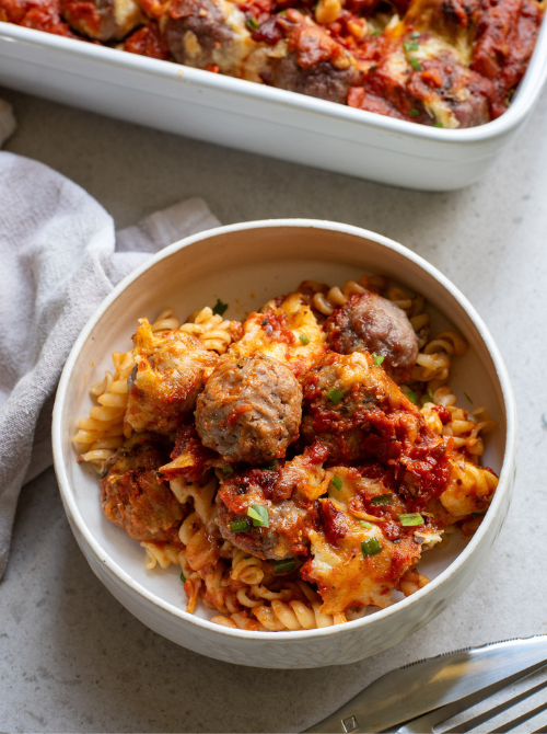 Baked pasta casserole with meatballs, melted cheese, and marinara sauce served in a bowl, a hearty comfort casseroles favorite for easy comfort food and recipes for busy nights.