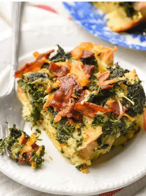 Slice of spinach, bacon, and cheese breakfast casserole served on a white plate, a savory option for make-ahead Easter brunch casseroles perfect for a holiday morning.