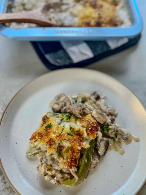 Philly cheesesteak casserole with creamy sauce, mushrooms, and melted cheese served on a plate, a hearty comfort casseroles choice for easy comfort food and recipes for busy nights.