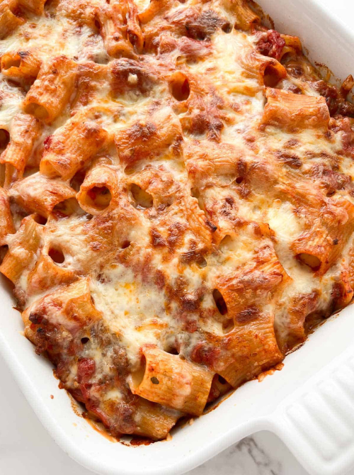 Close-up of baked rigatoni casserole with melted cheese and hearty meat sauce, a classic comfort casseroles dish for easy comfort food and recipes for busy nights.