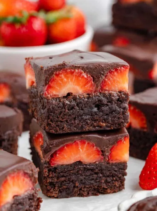 4:36 PMClaude responded: Two fudgy chocolate covered strawberry brownies stacked and showing halved fresh strawberries pressed into dark chocolate ganache — a summer strawberry dessert…Two fudgy chocolate covered strawberry brownies stacked and showing halved fresh strawberries pressed into dark chocolate ganache — a summer strawberry dessert that turns a box of brownie mix into something worth sharing.