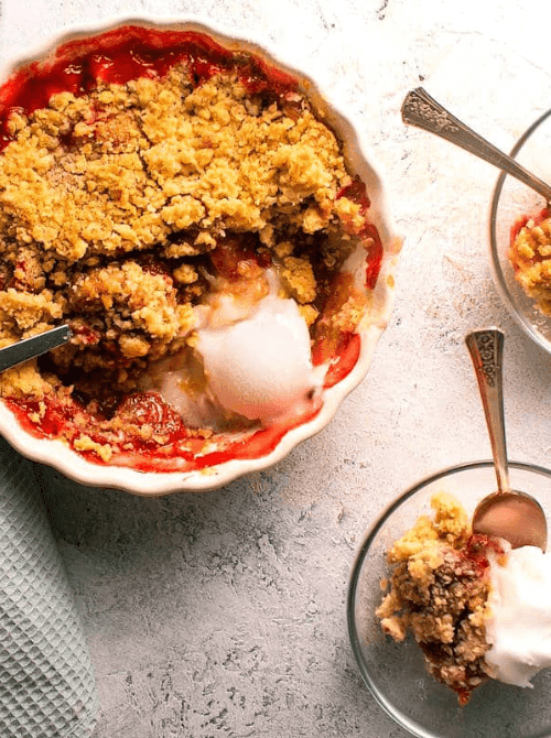 4:30 PMClaude responded: A white ruffled baking dish of strawberry crumble with a thick oat topping and melting vanilla ice cream, with individual servings plated alongside — an easy s…A white ruffled baking dish of strawberry crumble with a thick oat topping and melting vanilla ice cream, with individual servings plated alongside — an easy strawberry dessert recipe that works just as well for two as it does for a crowd.  